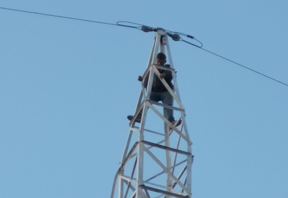 Tânăr coborât de pompieri de pe un stâlp de înaltă tensiune FOTO&VIDEO